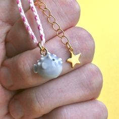 Get ready to be swept away by our adorable blowfish charm on a cozy cotton bracelet! This little porcelain puffer is dangerously cute and oh-so-tiny, guaranteed to steal your heart. The bracelet features a braided design and a golden star extension that adds a touch of charm to any outfit. Don't miss out on the cutest accessory around! 🥇 crafted from fine porcelain  meticulously hand painted in detail 🌳 heirloom quality ✔️ highly collectible 💝 individually gift boxed ✈️ free domestic shipping Blow Fish, Fish Bracelet, Cotton Bracelet, Fishing Bracelet, Animal Bracelet, Golden Star, Tiny Cottons, Fine Porcelain