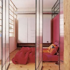 a bedroom with mirrored walls and a bed in the corner between two other rooms is shown