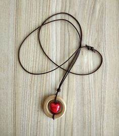 Stylish and warm!Made carefully and with love!Base made from apple wood, oiled.Cotton strap length can be adjusted.A great present for a friend or your-self! Best Valentine's day gift!Materials:Apple wood, cotton, ceramic.Pendant:Size in metric (about) 38 mm x 37 mm Size in imperial (about) 1.5 in x 1.46 in Cotton strap:Variable length, you can set it from 38 cm to 78 cm / 15 in to 30.7 inPackage:Packed in beautiful RM Accessories box, may be as a gift instantly!Please note that colors may vary Handmade Wooden Pendant Jewelry, Gift Wooden Bead Necklaces In Natural Wood, Natural Wood Necklaces With Wooden Beads For Gift, Handmade Wooden Necklace Gift, Wooden Pendant Necklace For Gift, Rustic Wooden Beads Jewelry As A Gift, Bohemian Natural Wood Necklaces As Gift, Bohemian Natural Wood Necklace As Gift, Rustic Jewelry With Wooden Beads For Gifts