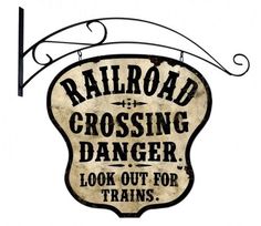 an old railroad crossing sign hanging from the side of a building with words reading railroad crossing danger look out for trains