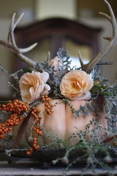 a cake with flowers and antlers on it