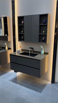 a modern bathroom with two sinks and cabinets in it's display area, along with an illuminated mirror above the sink