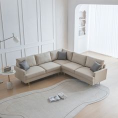 a living room with a sectional couch and rug on the floor in front of it