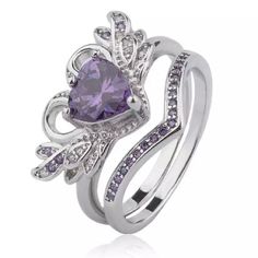 an engagement ring with a heart shaped amethorate surrounded by purple and white diamonds