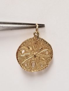 "Thanks for shopping our vintage estate store. We tend to sell well below wholesale and truly hope you enjoy all of our items. Many of the items are one of a kind, so please enjoy scrolling through the pictures and hopefully something will catch your eye. Spots are from the camera or reflections. Beautiful 14k yellow gold sand dollar pendant. Length: 1\" with bail Width: 3/4\" Weight: 2.61 grams Bail: 2mm Marked 14k,  as all our gold is marked and tested to be real gold. Beautiful pendant. As with most estate items there may be some wear on item. We do not sell new items, nor do we charge new retail prices." Sand Dollar Pendant, Garnet Heart, Charm Anklet, Gold Sand, Sand Dollar, Be Real, Ring Fit, Cz Diamond, Diamond Cut