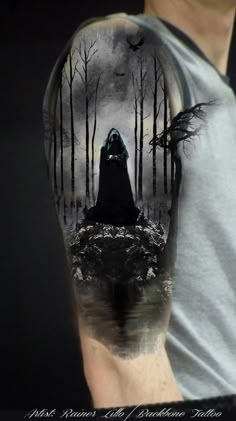 a man's arm with a black and white image of a person in the woods