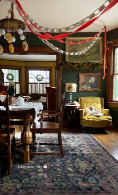 a living room filled with furniture and lots of red, white and blue decorations on the ceiling