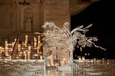 a room filled with lots of chairs and tables covered in white frosted cloths