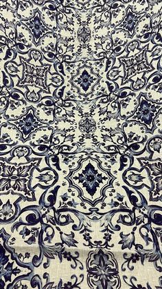 a blue and white area rug with an intricate design