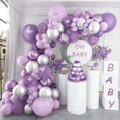 purple and silver balloons are on display at a baby shower