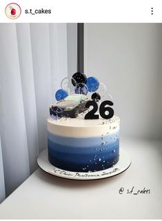 a blue and white cake sitting on top of a table