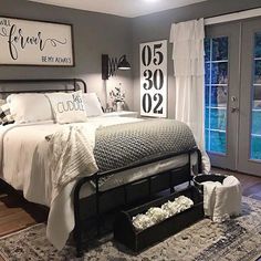 a bedroom with green walls and pictures on the wall