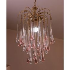 a chandelier with pink glass drops hanging from it