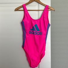 Adidas Swimsuit Brand New Neon Pink And Blue. Never Worn, Please Make An Offer! Sporty One-piece Pink Swimwear, Sporty Pink One-piece Swimwear, Sporty Pink Bodysuit For Summer, Pink Bodysuit For Swimming In Spring, Casual Pink Bodysuit For Poolside, Casual Pink One-piece Swimwear, Pink Sleeveless Bodysuit For Beachwear, Pink Sleeveless Beachwear Bodysuit, Fitted Adidas Swimwear For Pool