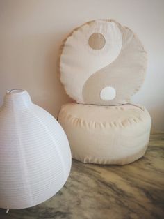 two white vases sitting next to each other on a table