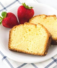 two slices of pound cake on a plate with strawberries