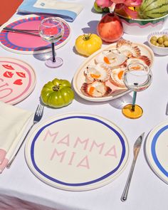 a table topped with plates and bowls filled with different types of food next to utensils