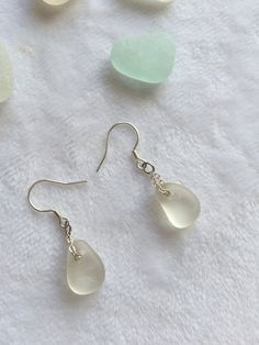 one pair of beautiful unique handmade S925 sterling silver  dangle earrings with water drop shape sea glass, each piece of sea glass I use is genuine sea glass was carefully hand collected from Seaham beach in North east England.  The earring total length is 3.4cm, the Sea glass size around 1.5cm.  All the finished jewellery come with beautiful box ready to be a gift to your care and love one.  PLEASE NOTE: earrings are sold as a pairs. Due to the nature of sea glass, the pieces in each pair are not identical to each other, they have been carefully selected as close as possible to match in shape, colour and size.  . If you have any questions please message me. Minimalist Teardrop Glass Jewelry, Glass Teardrop Jewelry With Matching Earrings, Silver Teardrop Earrings For Beach, Minimalist Glass Dangle Jewelry, Nickel-free Teardrop Glass Jewelry, Nickel-free Glass Teardrop Jewelry, Hypoallergenic Teardrop Glass Jewelry, Hypoallergenic Glass Teardrop Jewelry, Nickel-free Teardrop Glass Earrings