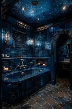 a bathroom with blue tiles and stars on the ceiling