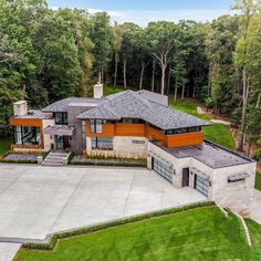 an aerial view of a large house in the middle of a wooded area with lots of trees