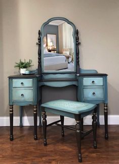 a bedroom with a blue vanity and mirror