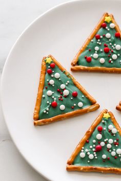 christmas tree cookies are arranged on a white plate