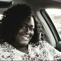 a woman sitting in the back seat of a car