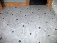 a bathroom with black and white tiles on the floor