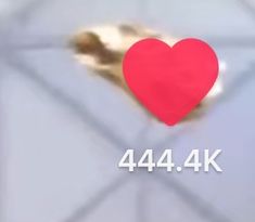 a red heart sitting on top of a piece of paper with the words 444 4k below it