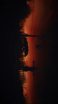 an airplane is flying in the sky over water at sunset or sunrise, with its reflection on the water's surface