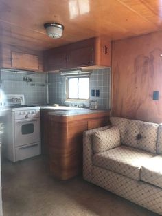 a kitchen and living room in an old mobile home