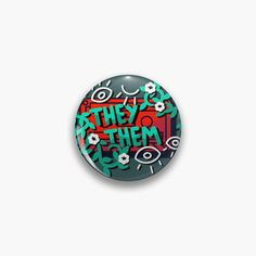 a button with graffiti on it that says the thing is in red and green letters