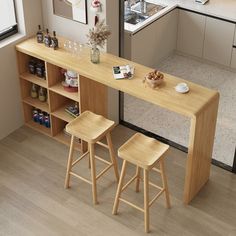 two stools sit at the counter in this kitchen