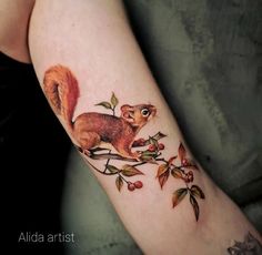 a small squirrel tattoo on the arm