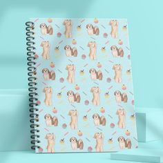 a spiral notebook with an image of dogs on it