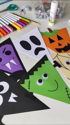 halloween crafts and supplies on a table with markers, crayons, pencils