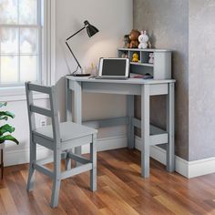 a small desk with a laptop on it and a chair in front of the desk