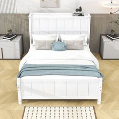 a white bed sitting on top of a wooden floor next to two nightstands and a rug