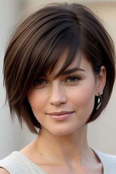 Discover the best haircut ideas for round faces for women that enhance your natural features and create a flattering silhouette. From layered cuts to textured bobs, explore a variety of styles designed to add dimension and elongate the face. Find inspiration for both short and long haircuts that balance your face shape and complement your personal style. Get expert tips on choosing the right haircut and styling techniques to achieve a polished, modern look that highlights your round face beautifully. Short Layered Bob Hairstyles Round Face, Below The Ear Haircut For Women, Round Layered Bob, Short Dark Hair Round Face, Chin Length Bob With Wispy Bangs, Best Haircut Round Face, Short Bob Haircut For Round Face, Short Length Haircut For Round Faces, Short Hair Styles For Heart Shaped Face