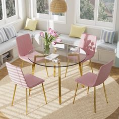 a glass table with pink chairs around it