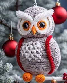 an owl ornament hanging from a christmas tree with ornaments around it's neck