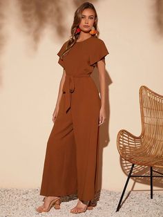 This elegant piece from our collection is a must-have for any wardrobe. Butterfly Sleeve Belted Wide Leg Jumpsuit is crafted from a lightweight fabric, the wide-leg silhouette is enhanced by a belted waistline and regular fit. Featuring a round neckline, short butterfly sleeves, and a long length, this piece is sure to bring a touch of sophistication to any look. It's perfect for any formal occasion or just to add some flair to your everyday style coming in black and brown colors. Features: Style: Elegant Pattern Type: Plain Details: Belted Length: Long Type: Wide Leg Fit Type: Regular Fit Neckline: Round Neck Sleeve Length: Short Sleeve Sleeve Type: Butterfly Sleeve Waist Line: High Waist Fabric: Slight Stretch Material: Woven Fabric Composition: 100% Polyester Body: Unlined Belt: Yes She Chic Belted Jumpsuits And Rompers For Spring, Chic Jumpsuits And Rompers With Belt For Workwear, Elegant Wide Leg Belted Jumpsuits And Rompers, Belted Wide Leg Jumpsuits For Work, Wide-leg Belted Jumpsuit For Work, Belted Wide-leg Jumpsuit For Work, Belted Jumpsuit For Spring, Belted Jumpsuits And Rompers For Spring, Chic Jumpsuits And Rompers With Belted Cuffs For Work