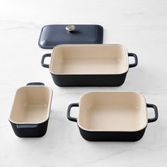 four black and white dishes on a marble counter