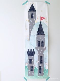 a piece of fabric with a castle on it and stars in the sky behind it