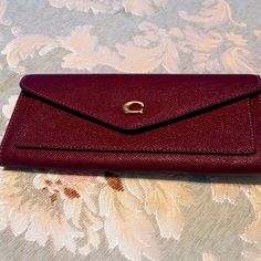 Coach Wyn Cross Grain Textured Leather Wallet. New With Tags. Color Is Deep Berry Multi. Signature Polished Hardware. Approximate Size Is 7 3/4" Length, 3 1/2" Height And 1/2" Depth. Concealed Snap Flap Closure. Exterior Slip Pocket. Interior Bill Compartment. Eight Interior Card Slots. Coach Wallets With Cell Phone Pocket For Daily Use, Coach Wallets With Removable Pouch For Formal Use, Formal Coach Wallet With Removable Pouch, Luxury Burgundy Wallet For Everyday Use, Elegant Burgundy Wallet With Interior Card Slots, Elegant Burgundy Wallet With Card Slots, Coach Elegant Wallet With Cell Phone Pocket, Classic Coach Clutch With Removable Pouch, Coach Classic Clutch With Removable Pouch