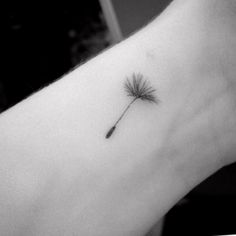 a small dandelion tattoo on the left arm is shown in black and white