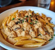 a white plate topped with pasta covered in sauce