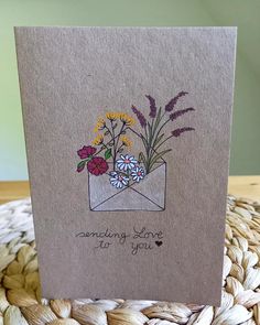 a card with flowers in an envelope that says sending love for you