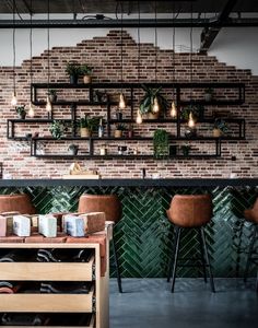 the interior of a restaurant with brick walls and potted plants