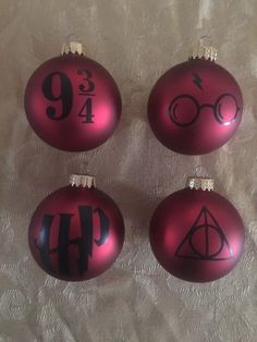 three harry potter christmas ornaments on a white tablecloth with the number nine, seven and eight